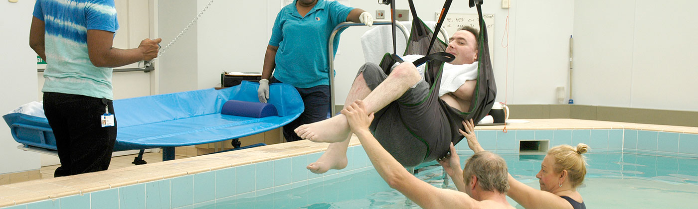 A patient being helped out of the aquability pool