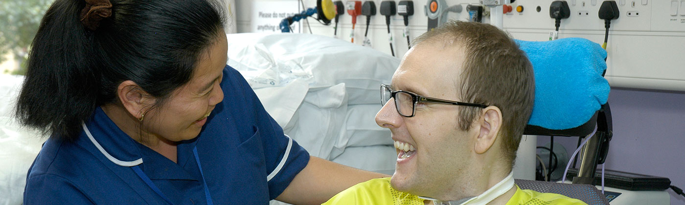 Nurse and patient with a brain injury on a ventilator unit