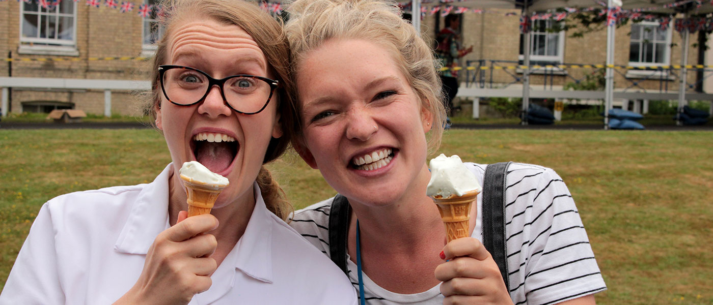 Two women eating ice cream and smiling