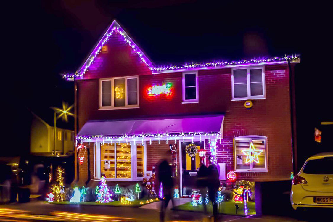 English house with outdoor Christmas light display