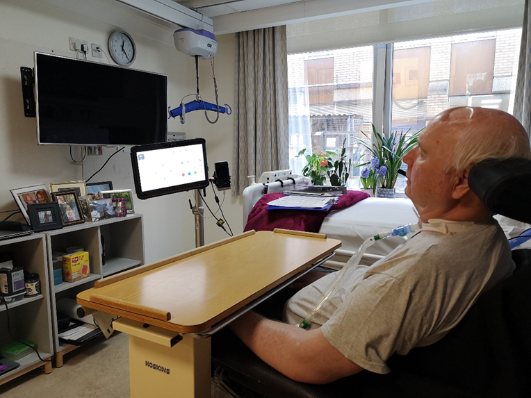 Resident Gary using AAC in his room